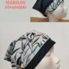 le Bandana Marilou Tropical (réversible) : un côté est noir uni, l'autre est orné d'un motif feuillage vert et bleu.